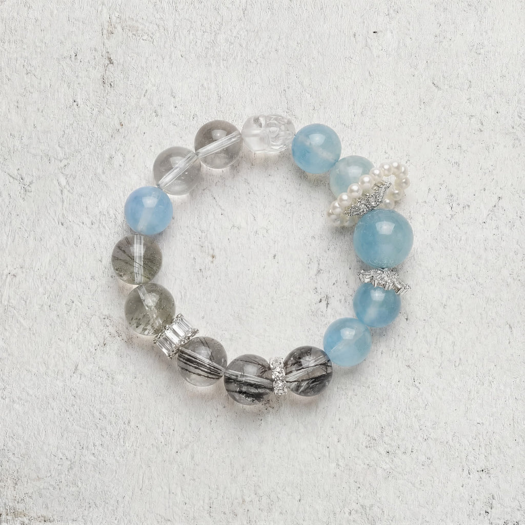Z03 Glacial Vox bracelet top-down on light gray — pale blue aquamarine and smoky phantom quartz